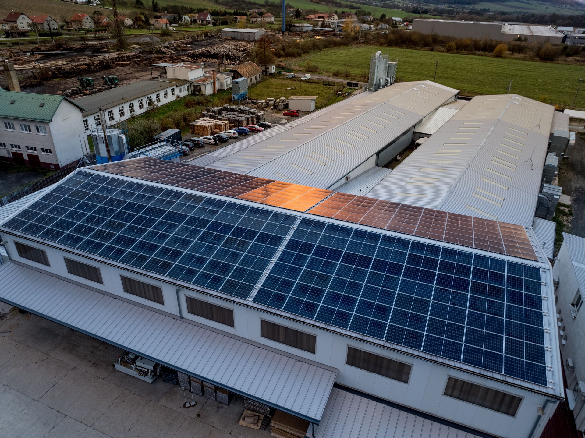 Aerial view of solar panels on a rooftop of factory. Solar energy as renewable energy source in business.