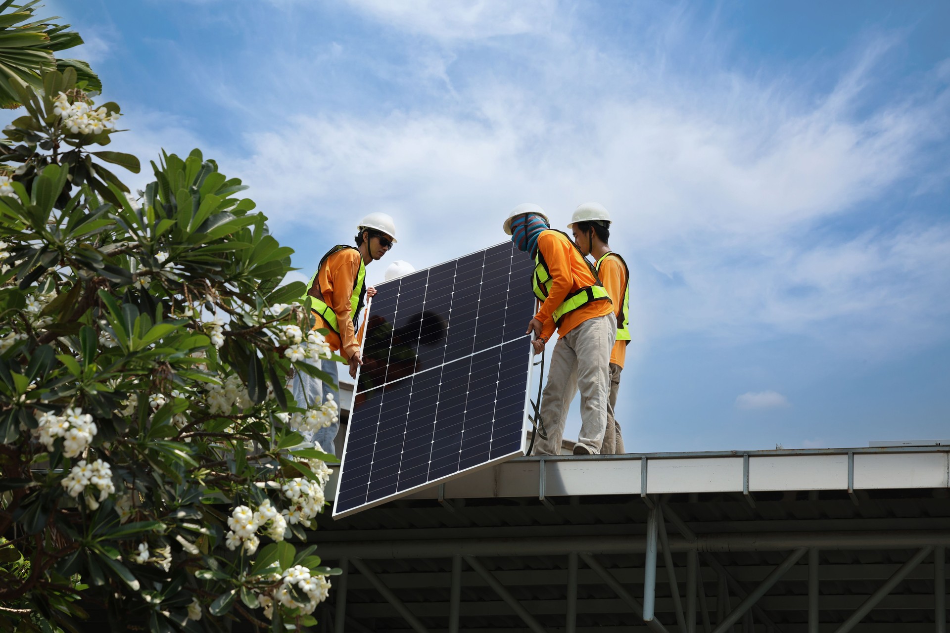 Technicians Install photovoltaic solar modules on roof of house. Engineers install or fix solar cells in roof of house. Technician worker on solar panels. Solar panel technician  working on house roof